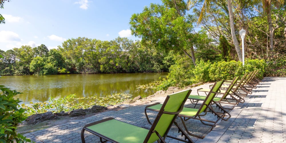 Lakeside seating at the pool at Quantum Lake Villas Apartments in Boynton Beach, Florida
