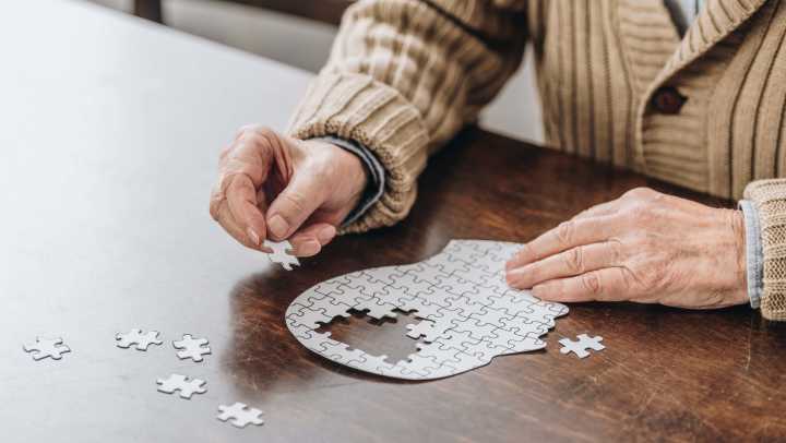 Old lady fixing a puzzle