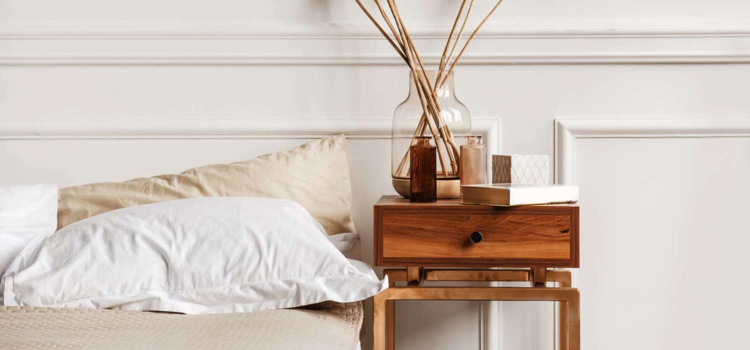 Cozy bedroom with a side table at Indian Terrace I Apartments in Auburn, Indiana