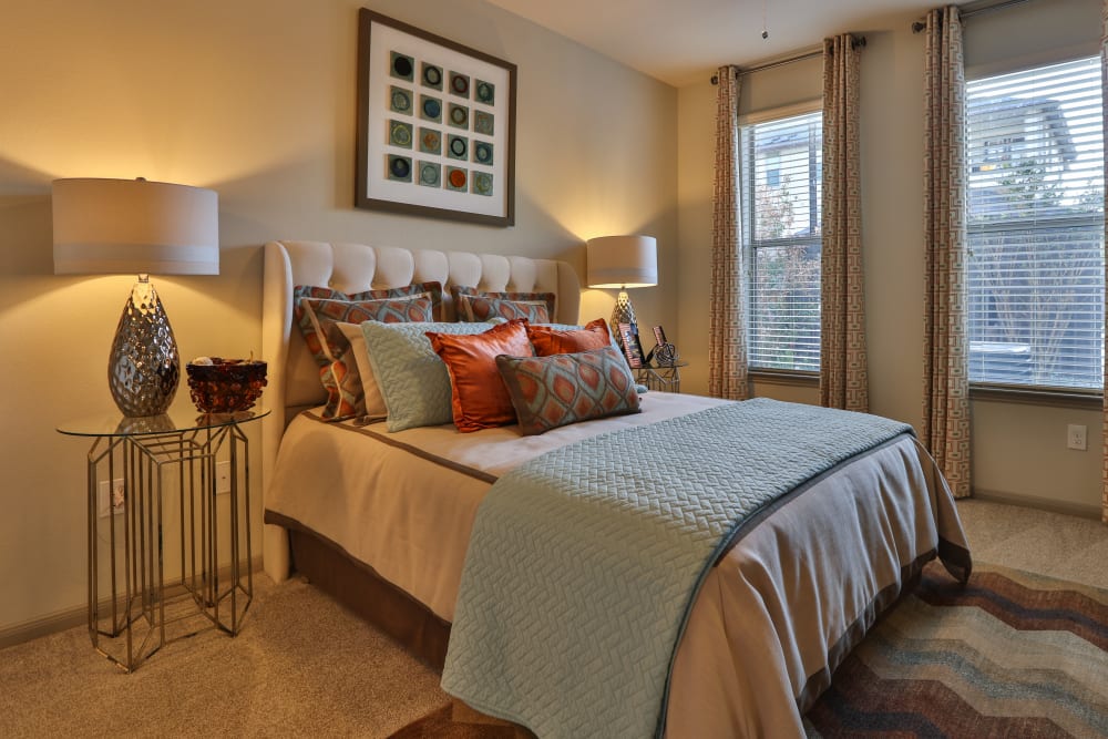 Ceiling fan and plush carpeting in a model home's bedroom at Olympus at Waterside Estates in Richmond, Texas