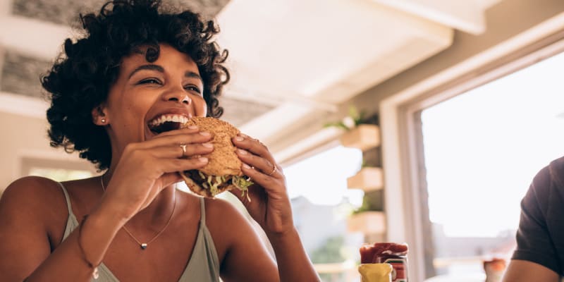 Resident eating a burger near Tuscany Woods Apartments in Windsor Mill, Maryland