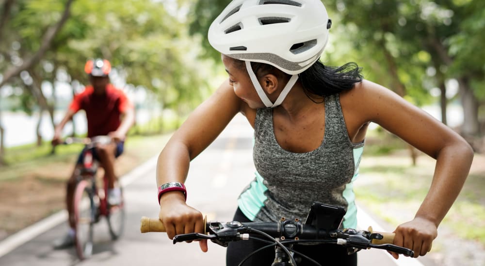 A woman and man riding bikes together near Mod Villas in Kingsland, Georgia