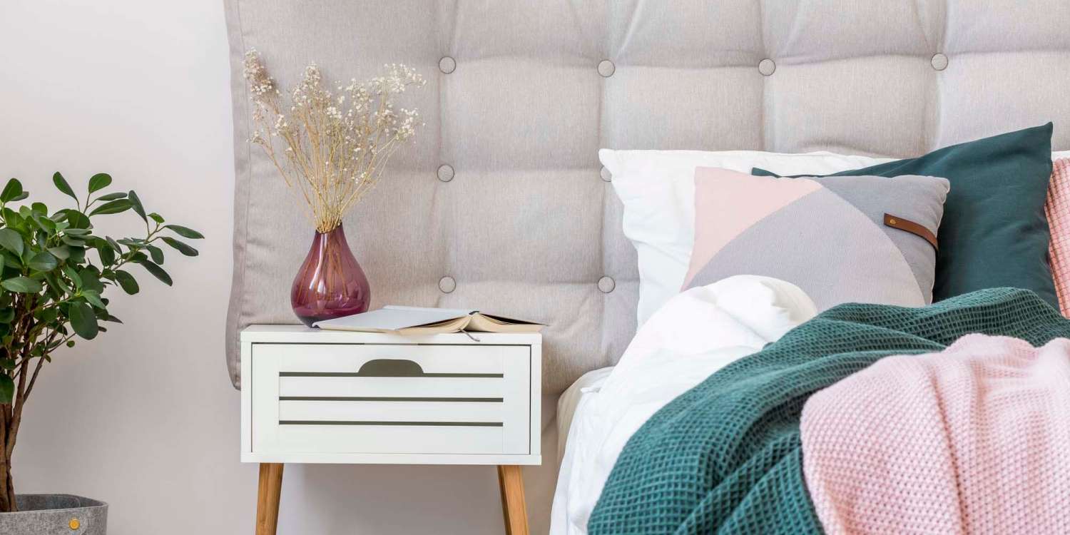 Bedroom with side table at Heron Creek Apartments apartments in Moses Lake, Washington