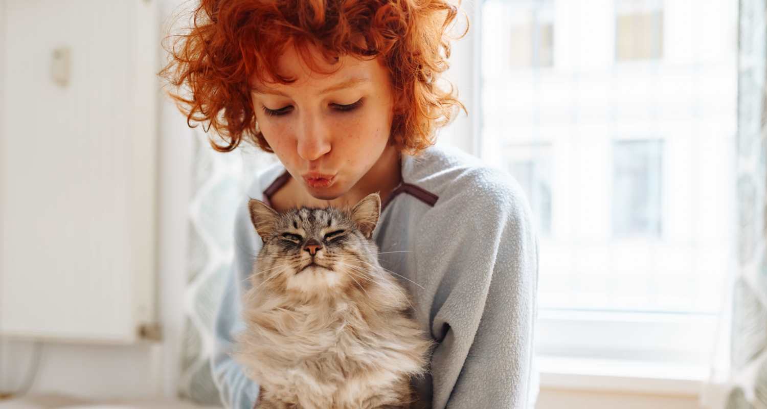 Resident playing with her cat in the pet-friendly community at Lanewood Pines in Hollywood, California
