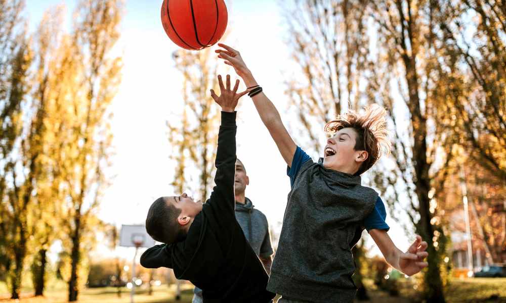 Resident kids playing basketball at Riverwood Apartments in Reno, Nevada