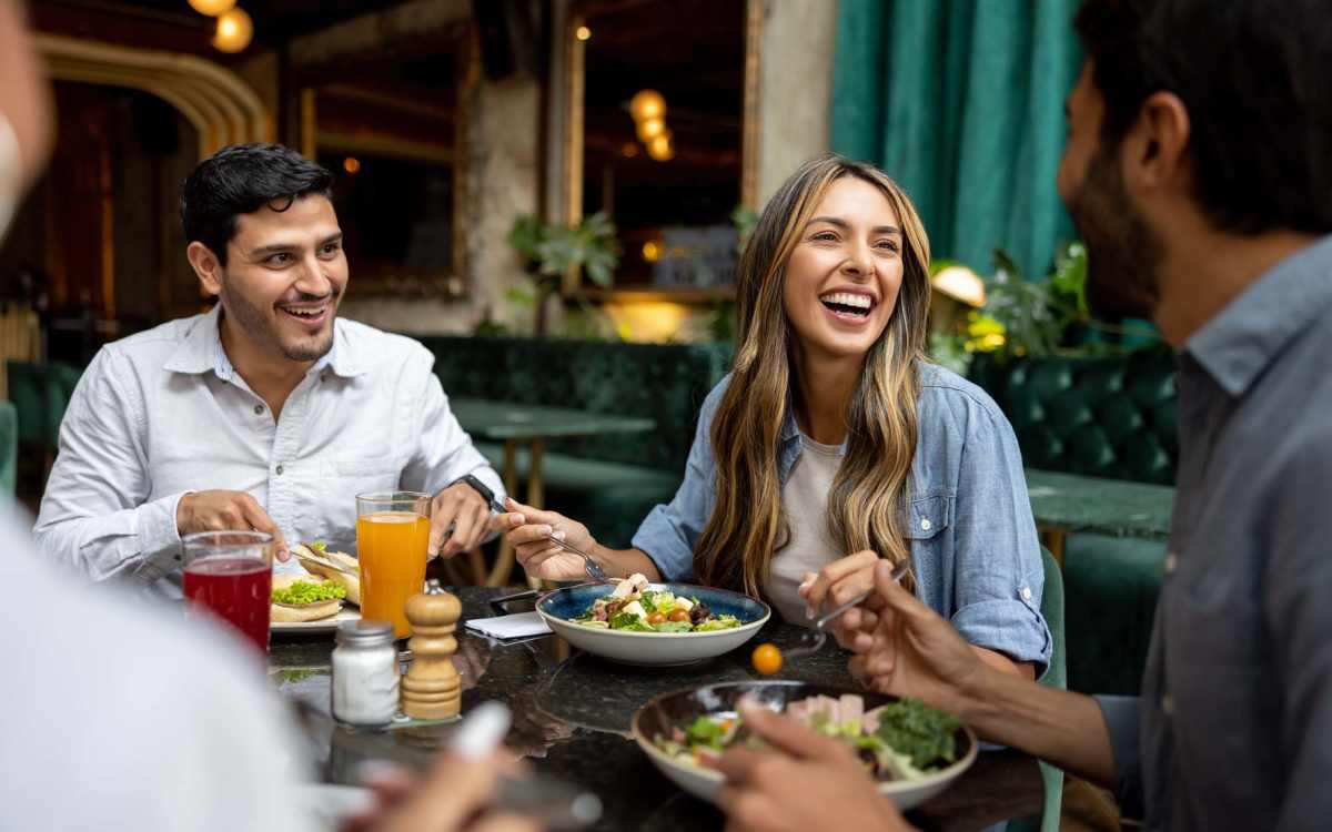 Residents eating lunch at a restaurant near InTown Apartments in Miami, Florida