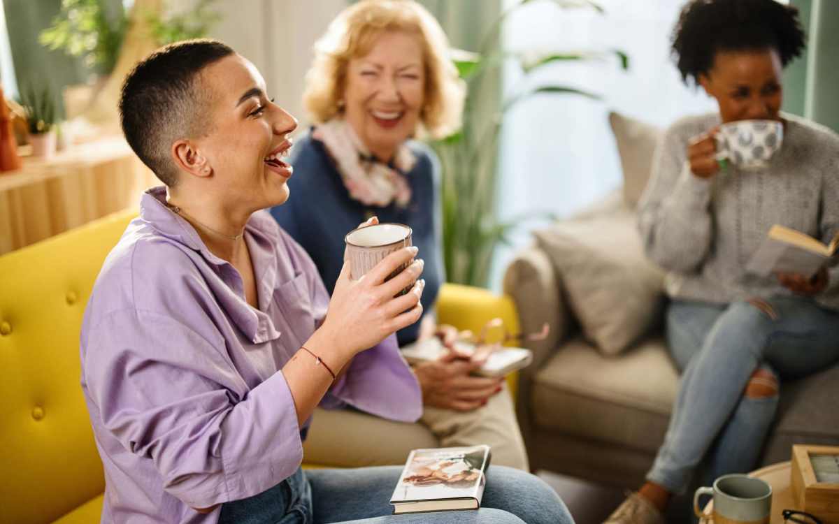 Resident friends having talk in community room at Maplewood Court in Bridgeport, Connecticut