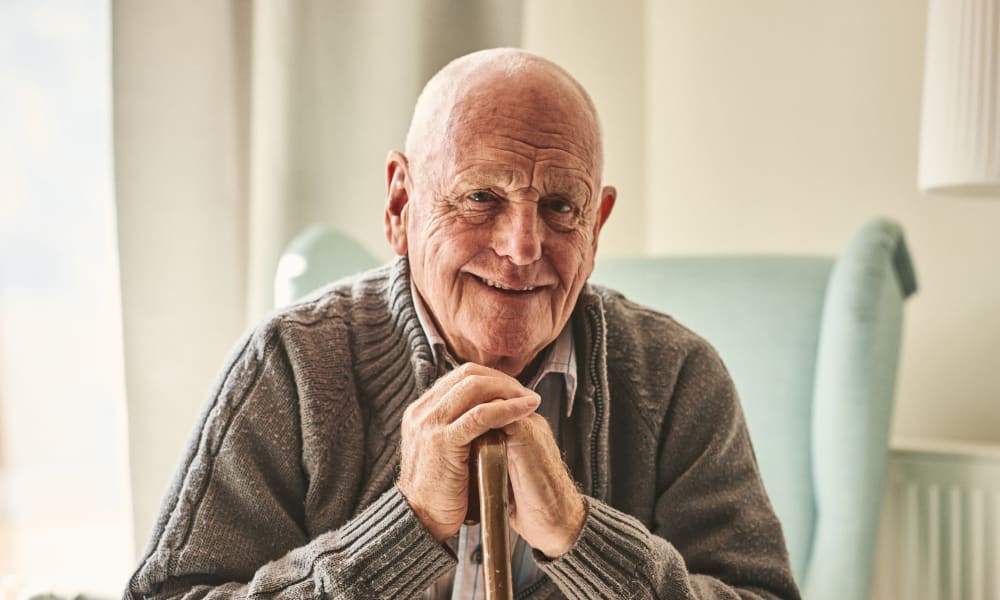A resident with a cane poses for a picture at Ativo Senior Living of Yuma in Yuma, Arizona.