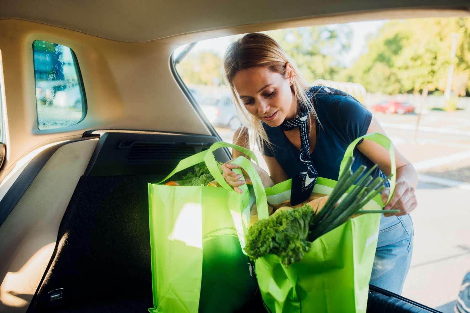 Resident loading groceries in her car near Spring Hollow Apartments in Brighton, Colorado