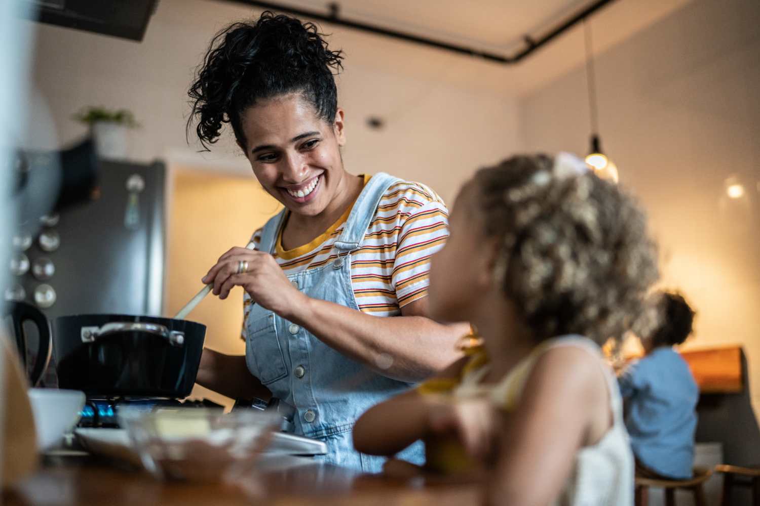 Resident woman cooking with her daughter in the modern kitchen at at Southridge Commons in Lafayette, Indiana