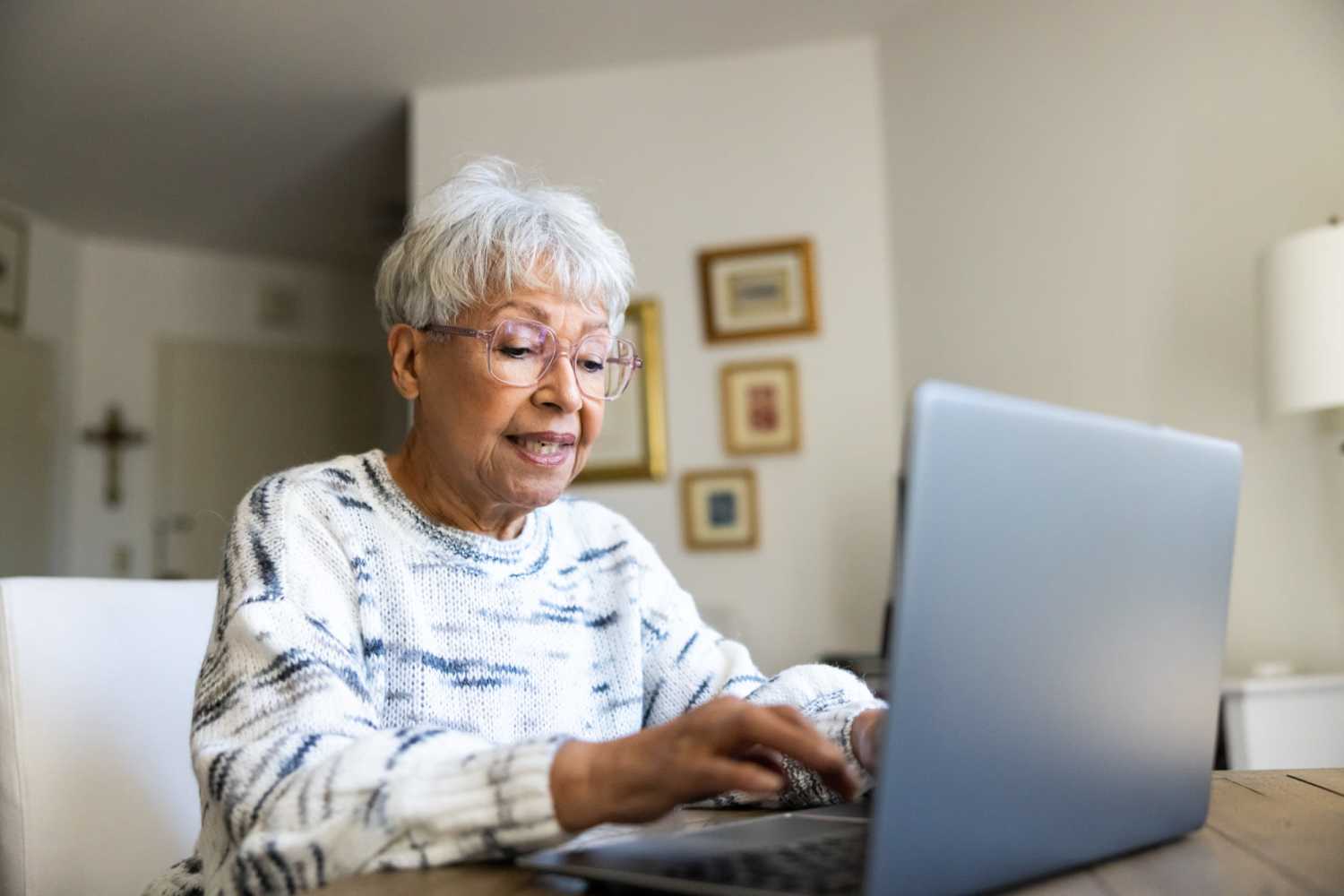 Resident working on her laptop in her apartment at Shire Crest Acres in West Unity, Ohio