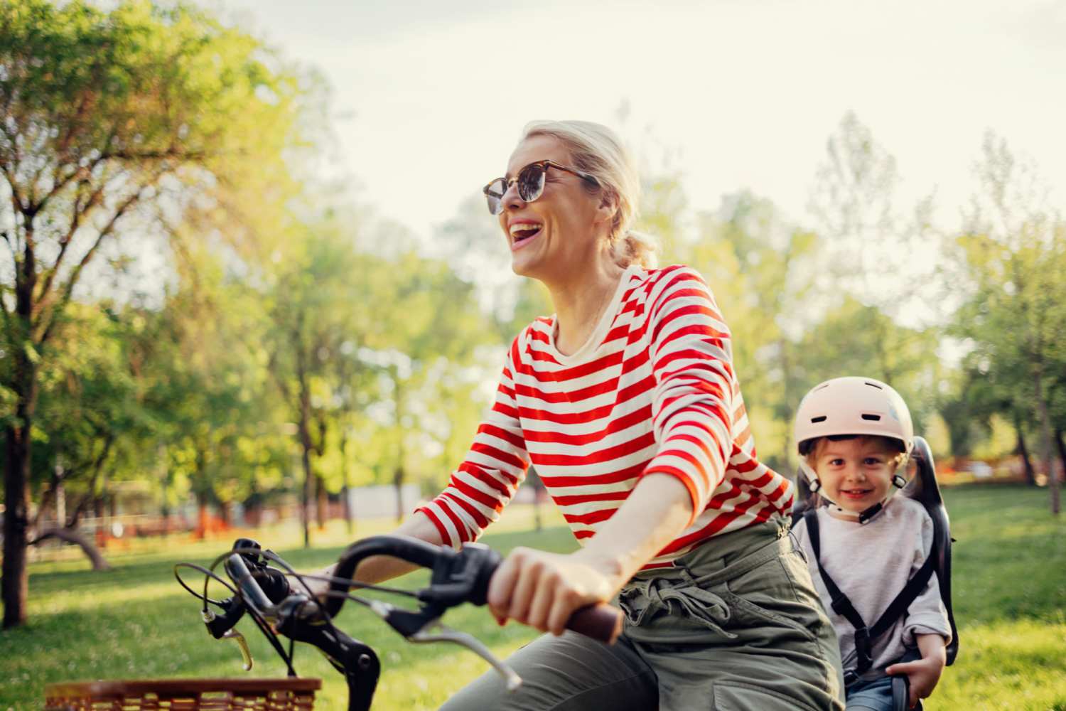 Resident woman with her son cycling in a park near Walnut Trace in Raleigh, North Carolina