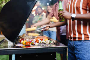 Resident grilling fresh veggies and meat at a lively party at Copper Ridge in Kennewick, Washington