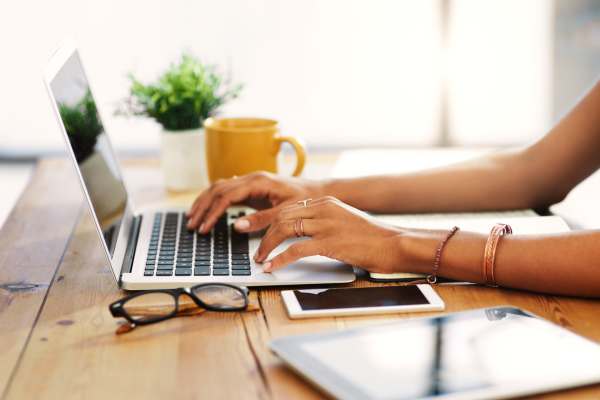 Resident typing on a laptop at Casa Aliento in Oxnard, California