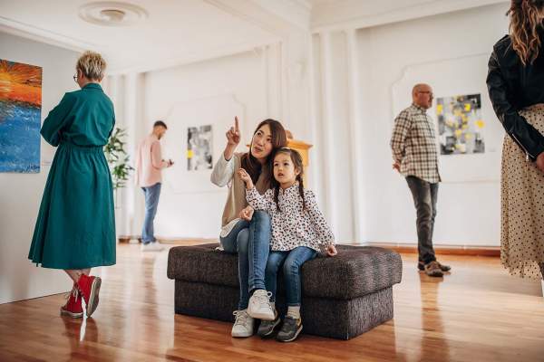 Resident woman with her daughter in an art gallery at St. James in Dallas, Texas
