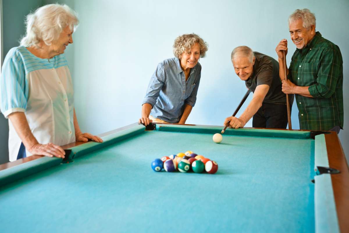 Elder residents playing in the clubhouse at Villas at Stone Hogan in Atlanta, Georgia