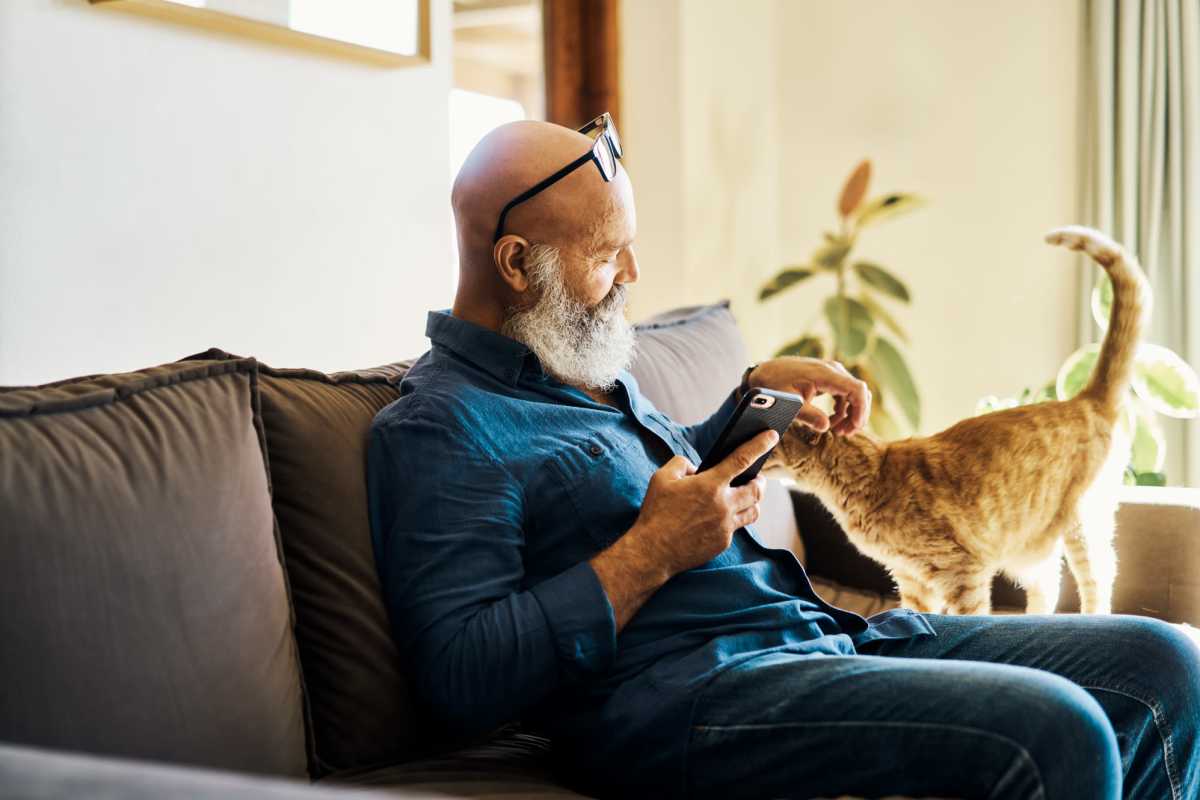 Resident playing with his cat at River Ridge in Sand Springs, Oklahoma 
