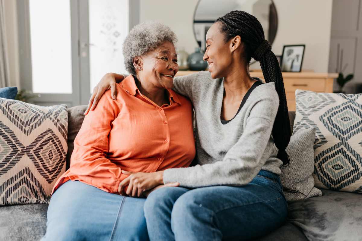 Cozy living room with two women sharing a warm moment at Villas At Meadow Springs in Ankeny, Iowa 