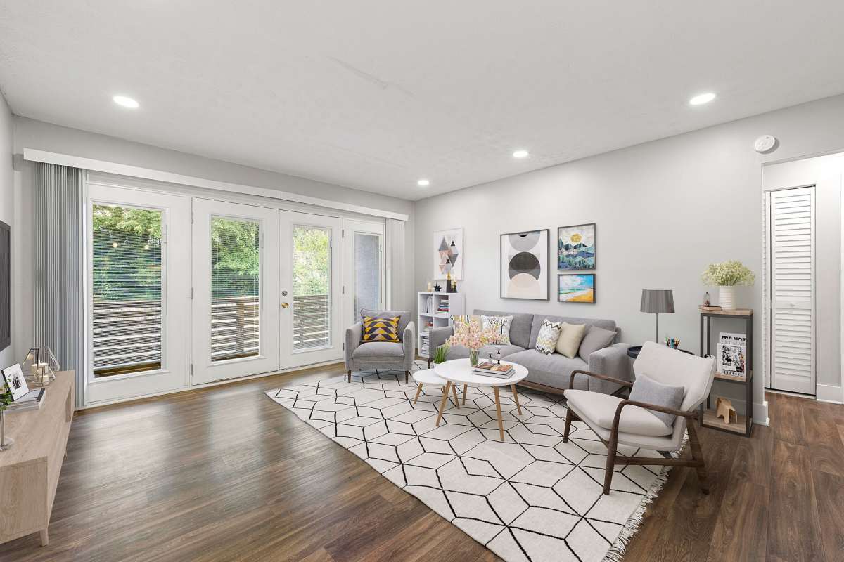 Living room with access to private balcony at Balfour Chastain in Sandy Springs, Georgia