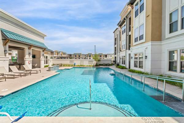 Resident dipping her toes in the pool at Cypress Creek at South Cedar in Temple, Texas
