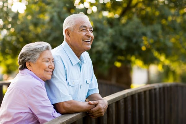 Couple standing on a bridge near Peninsula Reflections in Colma, California