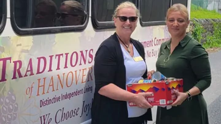 Executive Director of Traditions of Hanover Cathy Heimsoth delivers nonperishables and toiletry items collected by the residents at Traditions of Hanover. With her is Jenny Ramos from New Bethany Ministries