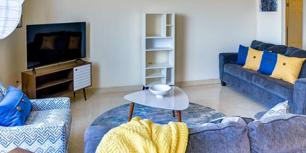 Living room with blue and yellow accent pillows and blankets  at Capitol Green in Albany, New York