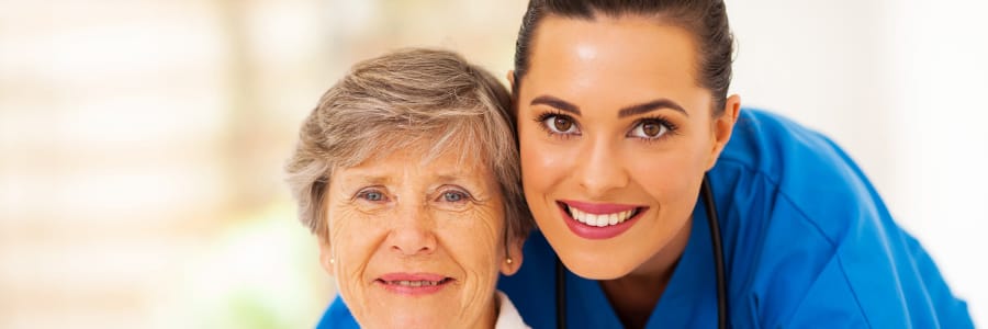 Resident with smiling caregiver at Holton Manor in Elkhorn, Wisconsin