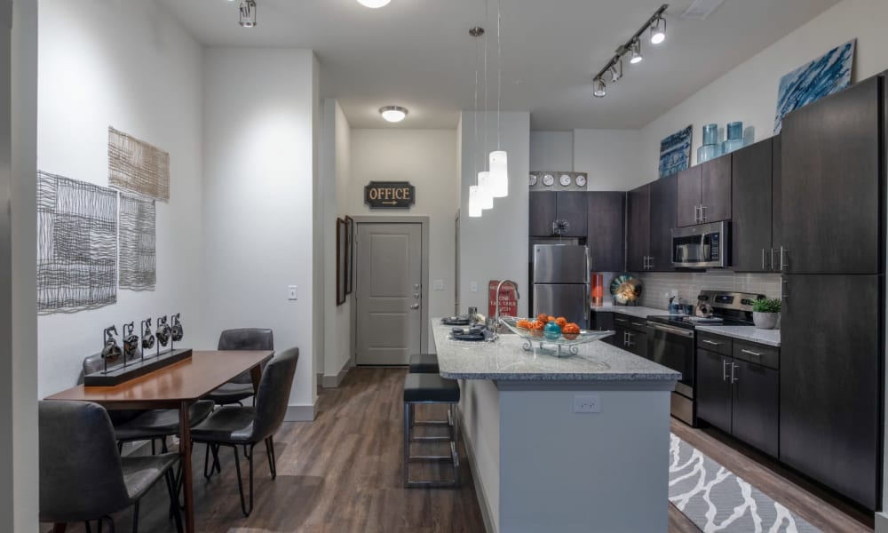 Kitchen with island for cooking and eating on at Bellrock Upper North in Haltom City, Texas