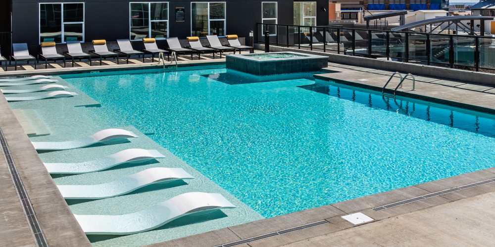 Pool with lounge beds at Legends 267 Apartments in Kansas City, Kansas