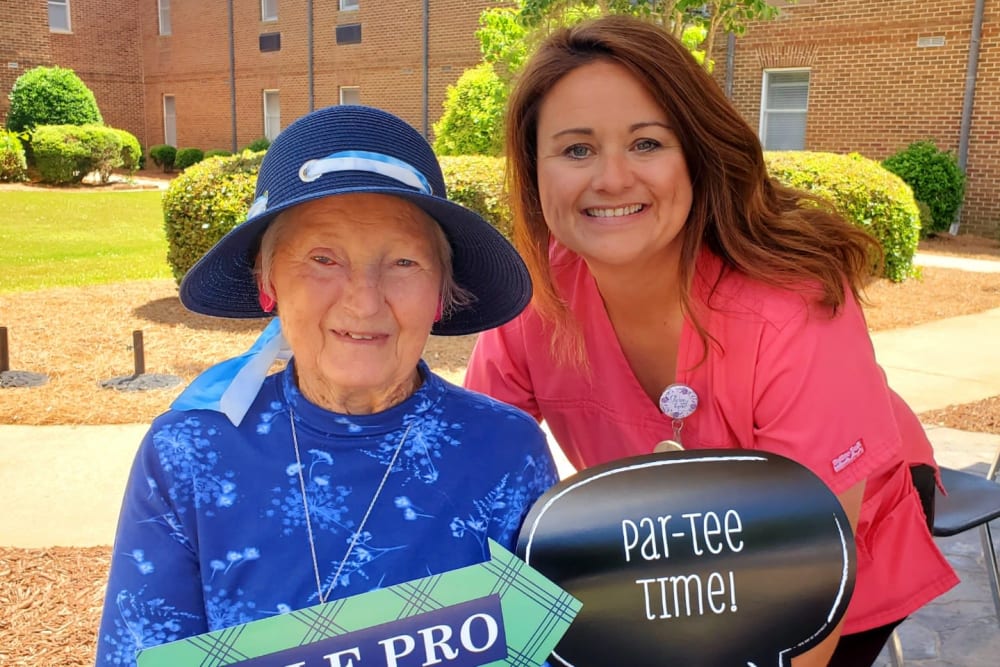 Resident taking a photo with a caretaker at The Clinton Presbyterian Community in Clinton, South Carolina