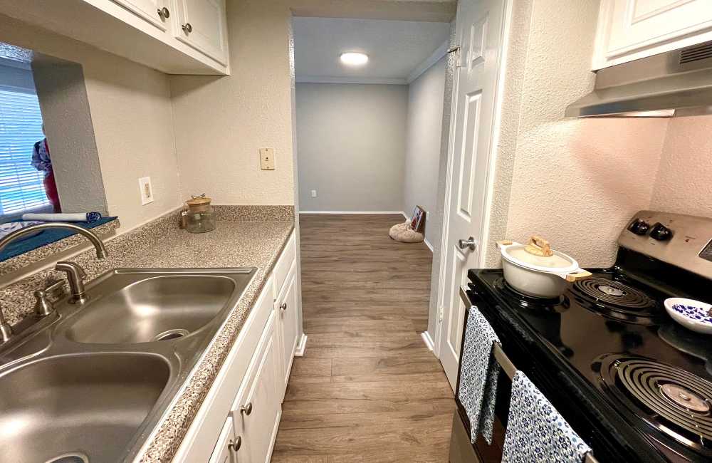 Modern kitchen with granite countertops at The Abbey at Briargrove Park in Houston, Texas