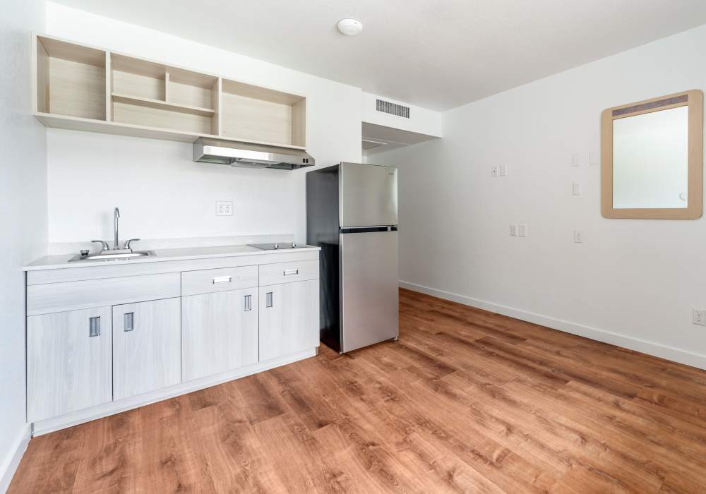 Modern kitchen with wood-style flooring at Valley View Homes in Centralia, Washington