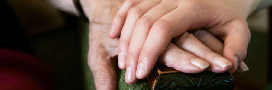 Resident and caregiver holding hands at Wellington Meadows in Fort Atkinson, Wisconsin