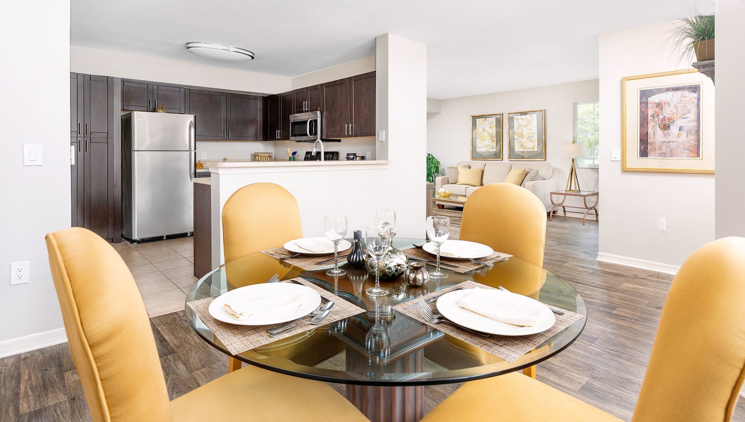 Dining table and kitchen at Weston Place Apartments in Weston, Florida