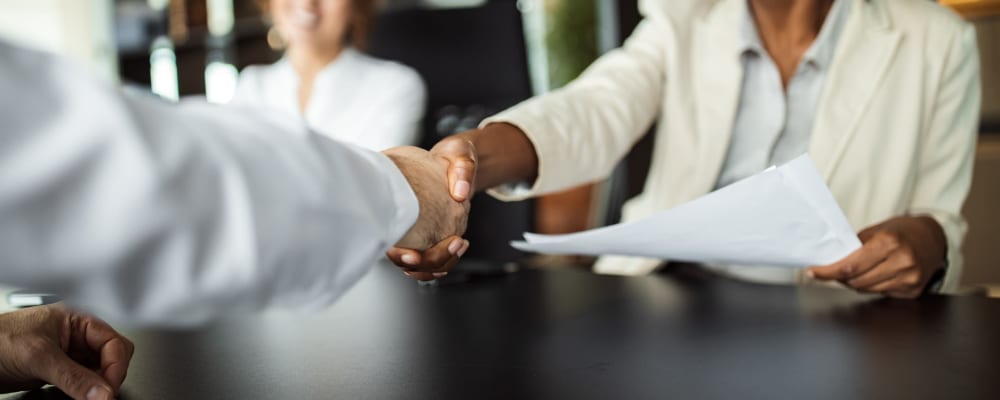 Two people shaking hands at Ridgeline Management Company in Rockwall, Texas