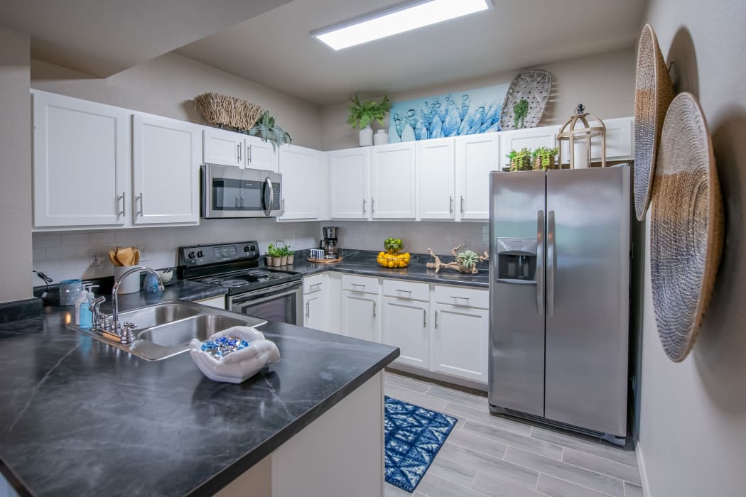 Kitchen with stainless-steel appliances at Stonehorse Crossing Apartments in Oklahoma City, Oklahoma