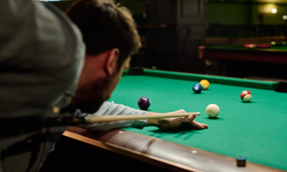 A man playing billiards table near Altitude on Main in Richmond, Virginia