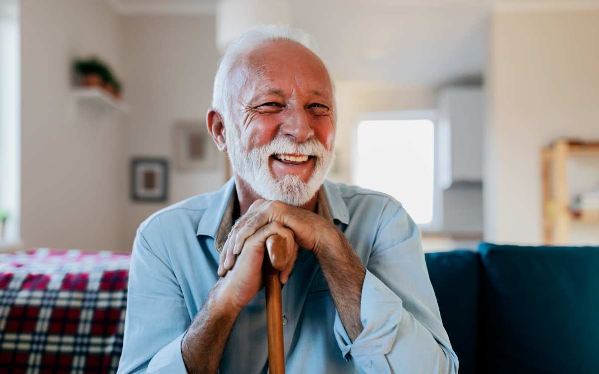 Man seating and smiling in living room at The Cascalote in Glendale, Arizona