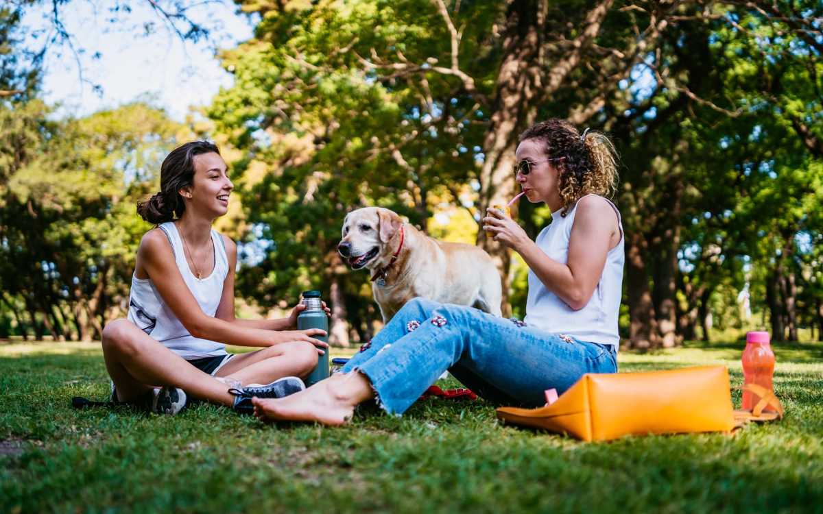 Residents with a dog in a nearby park at Cape Fear Townhomes in Fayetteville, North Carolina