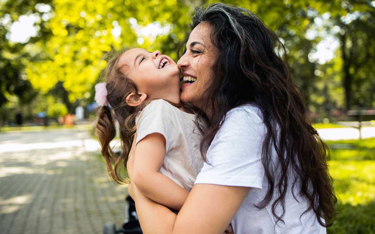 Mother and daughter cudlling in park near Stonebridge Manor Apartments in Gretna, Louisiana