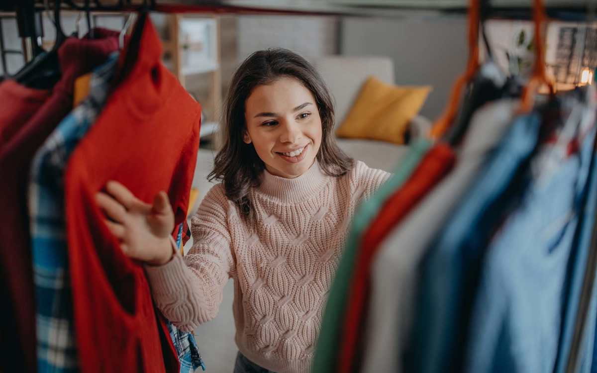 Resident searching clothes in a closet at Oasis in Miami, Florida