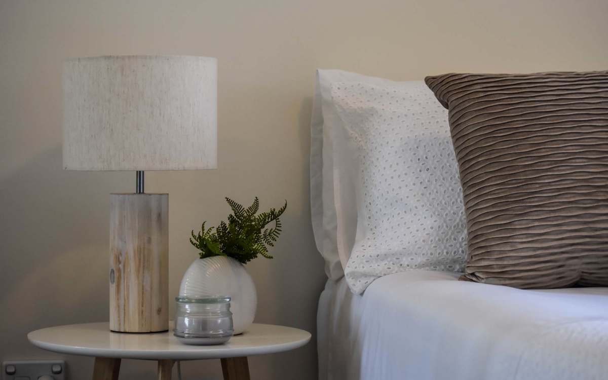Cozy bedroom with textured pillows at Mosaico Family Housing in Burien, Washington