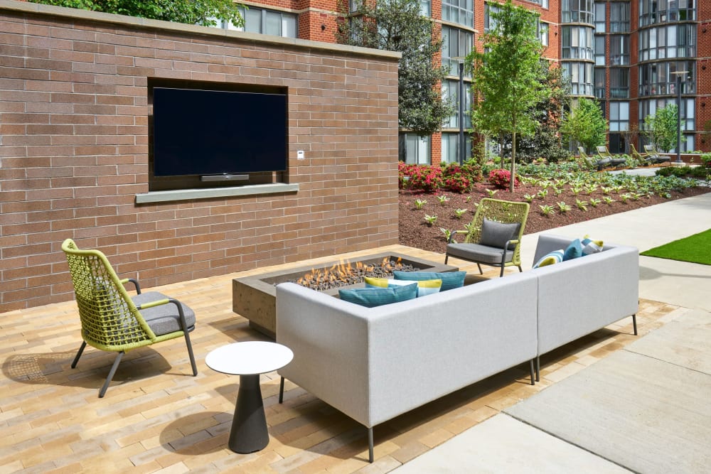 Renovated fire pit and TV at Meridian at Courthouse Commons