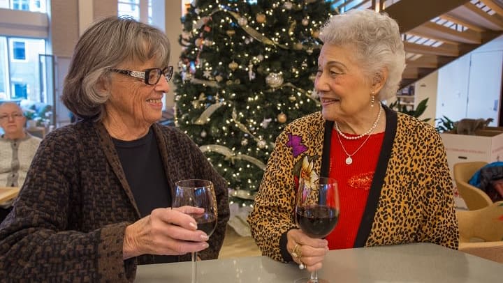 Friends having a glass of wine at our senior living community