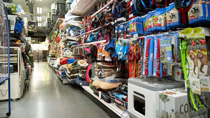 an aisle at a pet shop with pet leashes and dog beds | pet stores in Irvine
