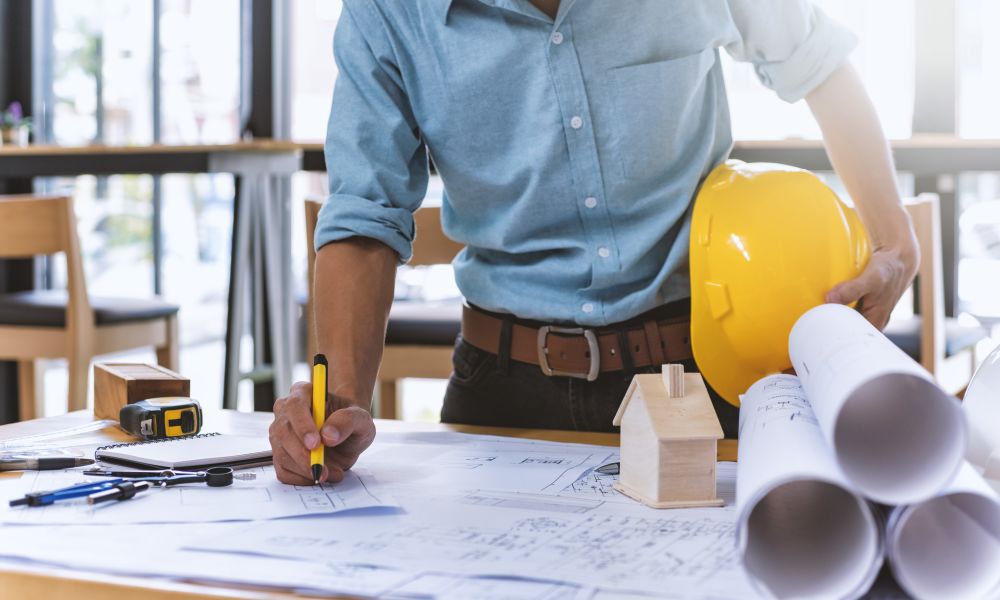 One of our project managers reviewing blue prints at a job site for another construction project by American Capital Group in Bellevue, Washington