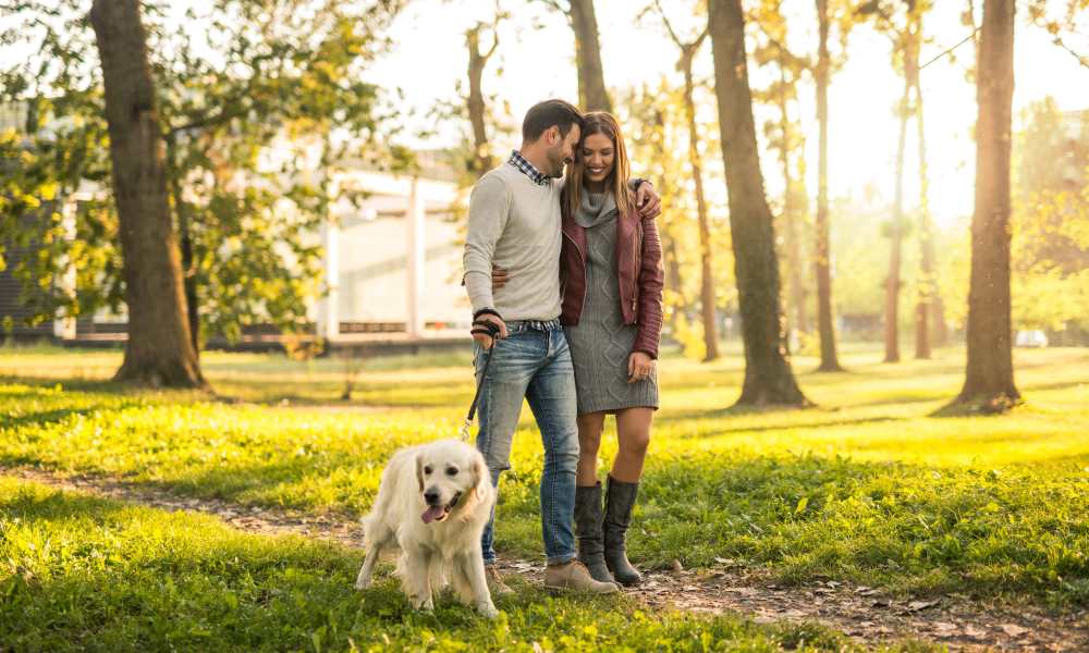 Couple walking their dog in a local park near Hawthorn at Oakhurst in Aurora, Illinois