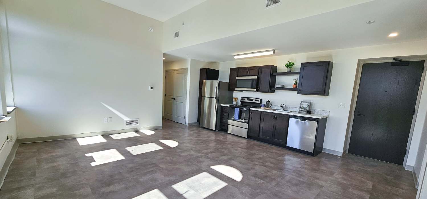 Luxurious kitchen with wood cabinetry at Academy Manor in Grand Rapids, Michigan