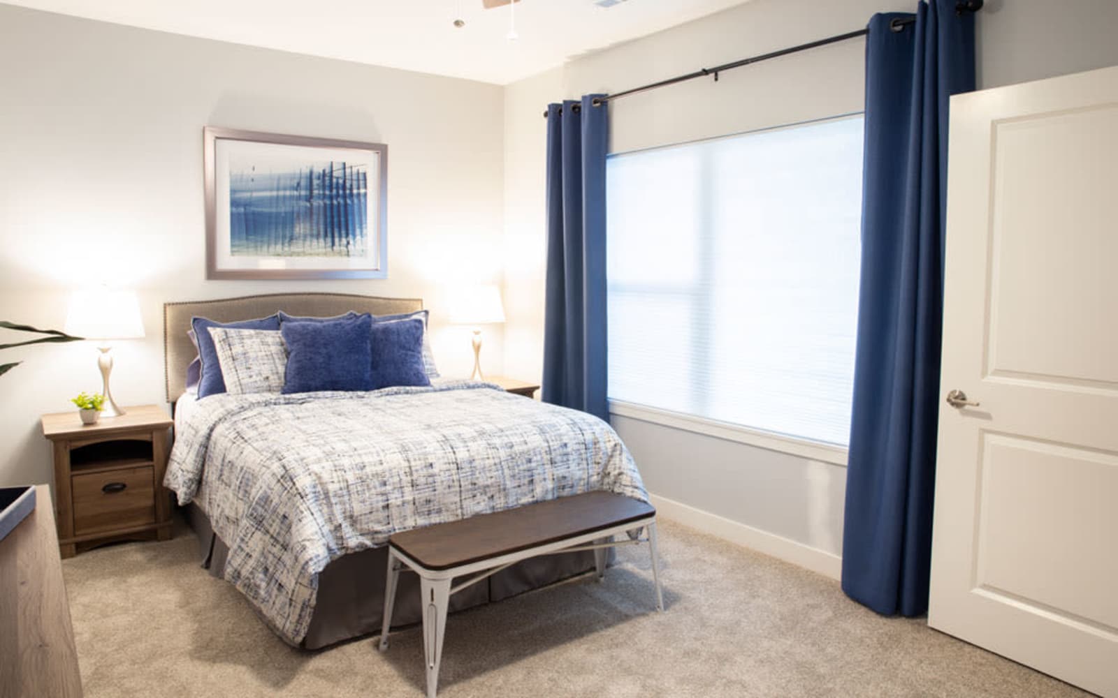 A bedroom with a large window at Attivo Trail Waukee in Waukee, Iowa